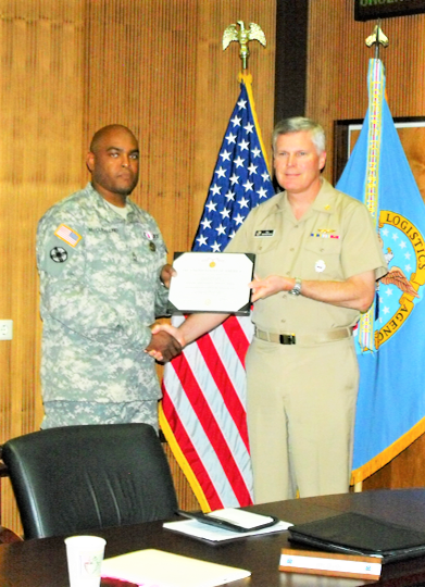 Larry McClelland receives and official award and recognition from VADM Thompson in DLA Europe & Africa Stuttgart, Germany
